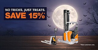 Forklift and pallet jack in front of a full moon with bats flying and leafless tree branches on the right